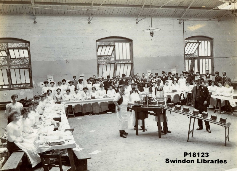 Mr Harvey-Freeman's patent cake-cutting machine in use at the Drill Hall. Part of the preparations for the GWR Children's Fete.